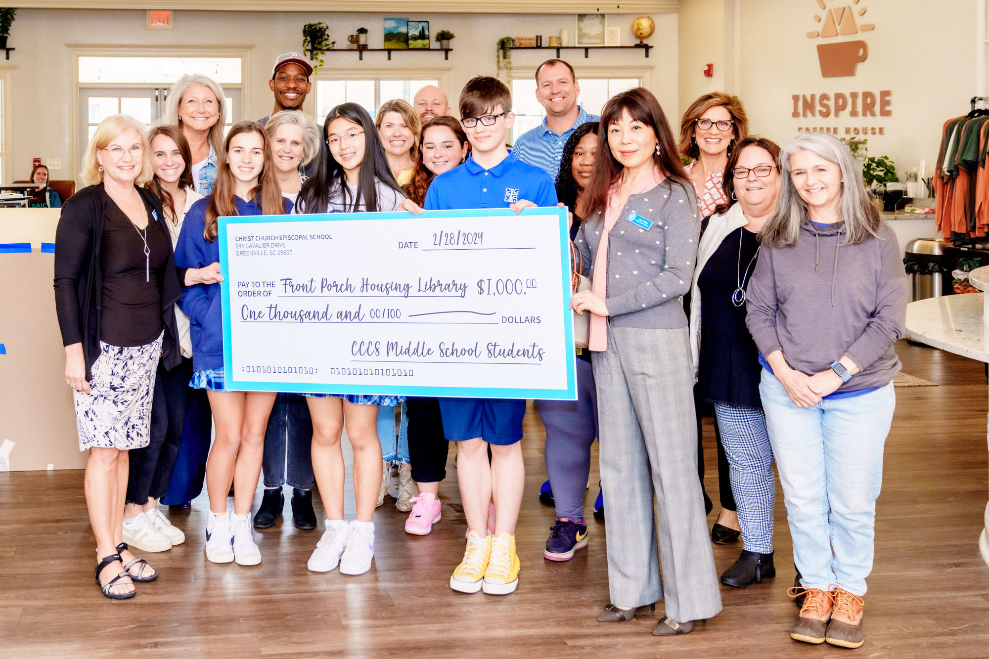 People Holding Check for $1,000 - a donation to Front Porch Library from CCES Middle School